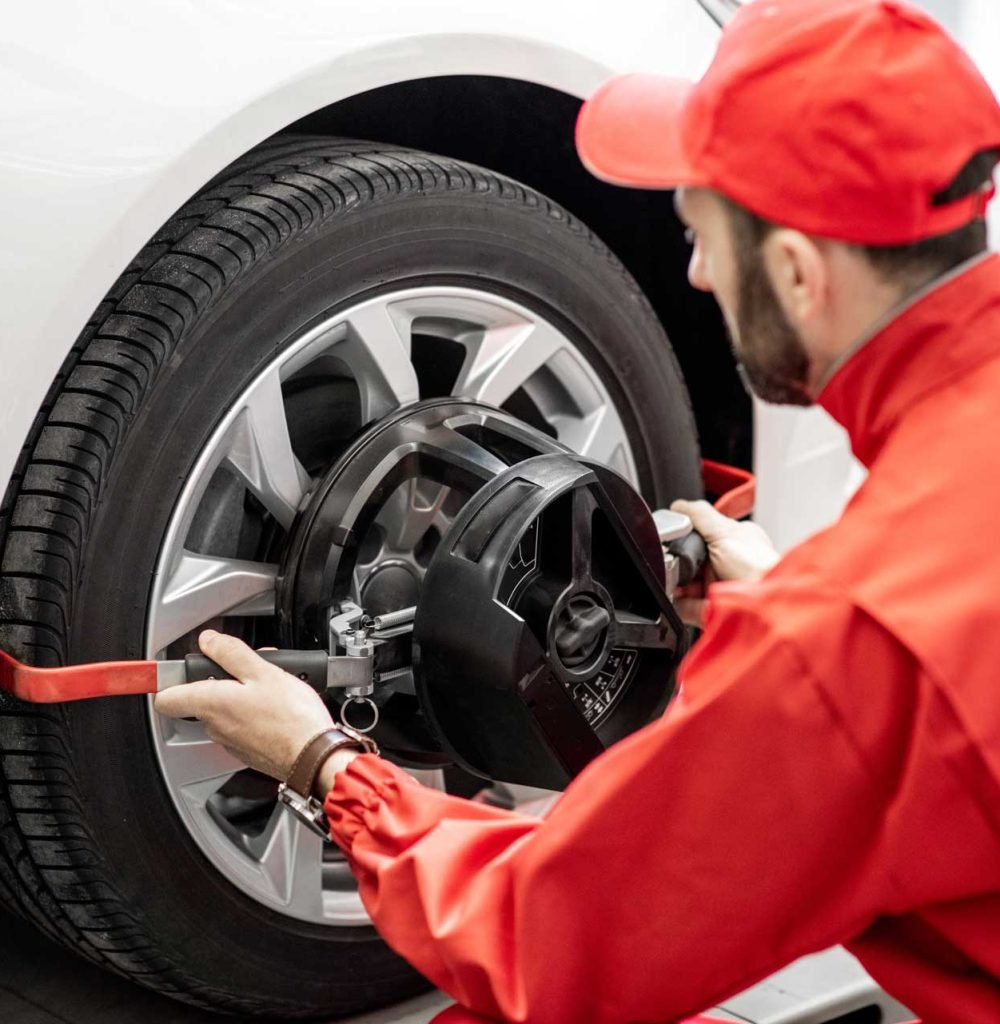 auto-mechanics-making-wheel-alignment-at-the-car.jpg